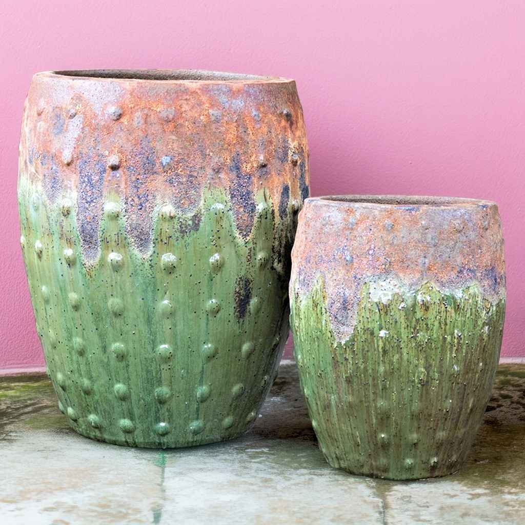 Barrel-shaped green planters featuring a rustic textured dripping effect and raised dot detailing