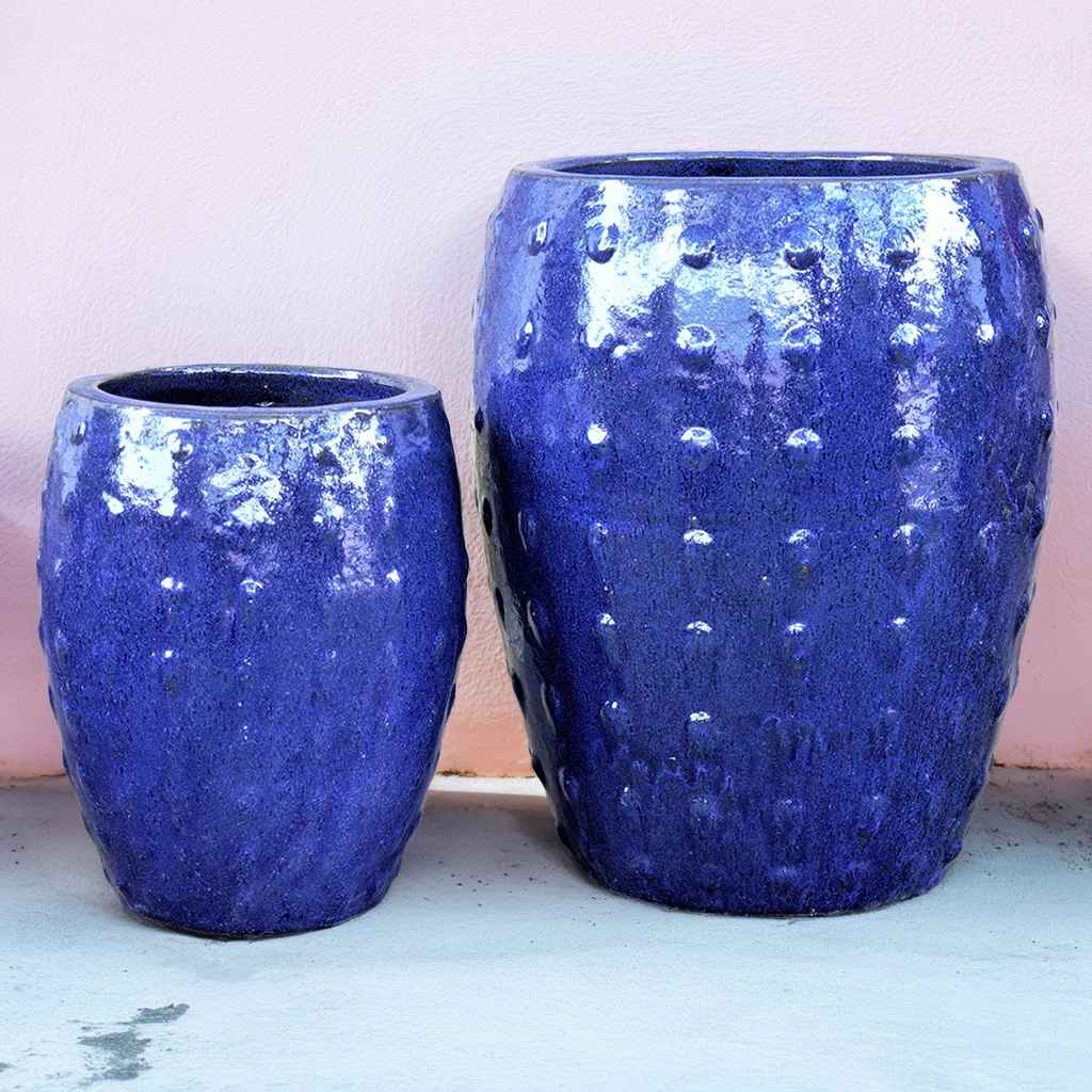 Barrel-shaped planters in glazed blue featuring a raised dot texture