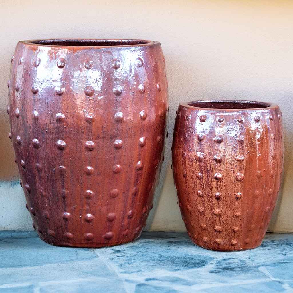 Barrel-shaped planters in glazed brown featuring a raised dot texture