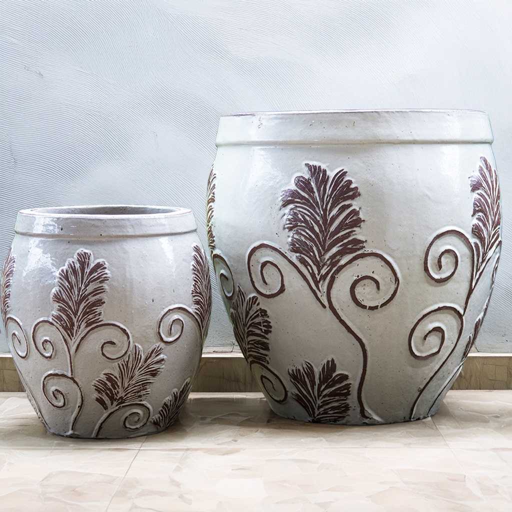 Set of 2 Rounded ceramic planters in white featuring a detailed brown ornate leaf design