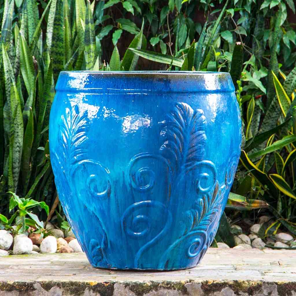 Rounded blue ceramic planters featuring a detailed brown ornate leaf design