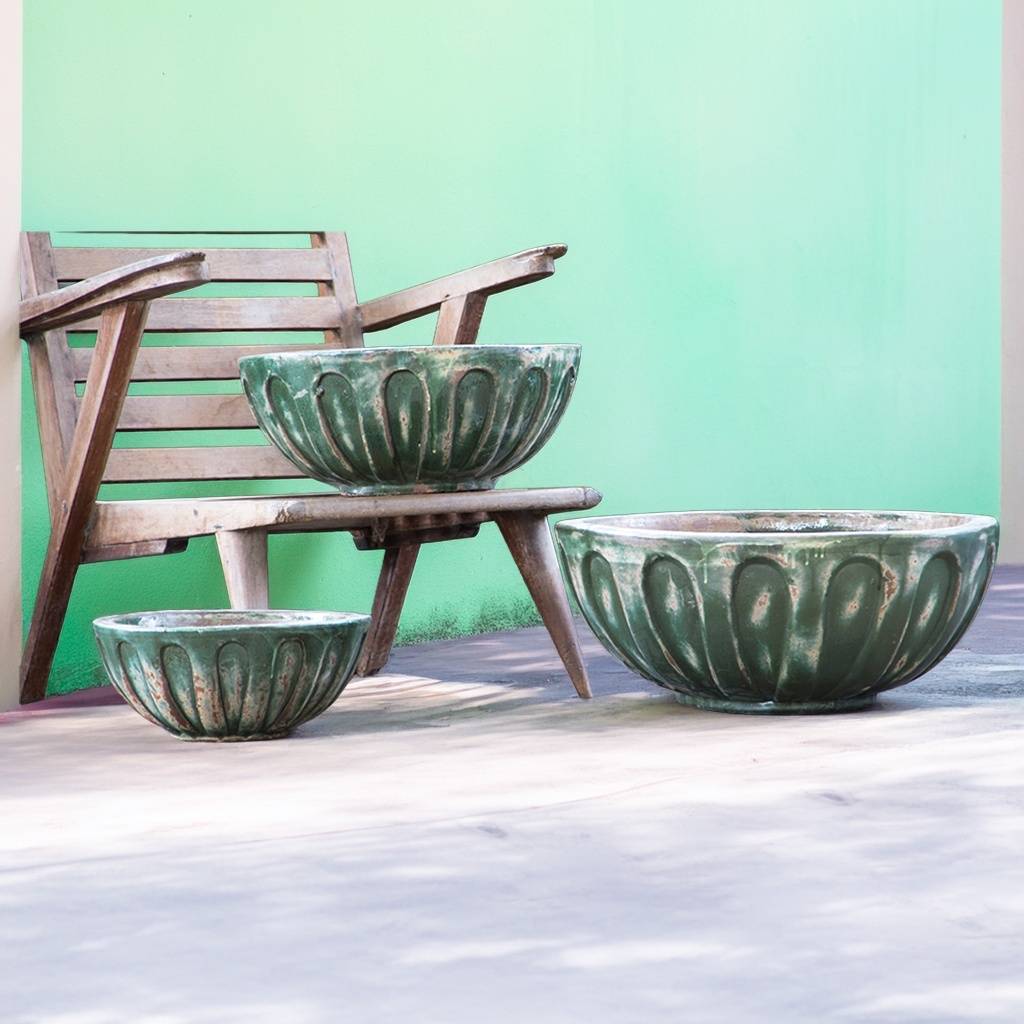 Round low bowl ceramic planters in deep olive green with a weathered, rustic finish
