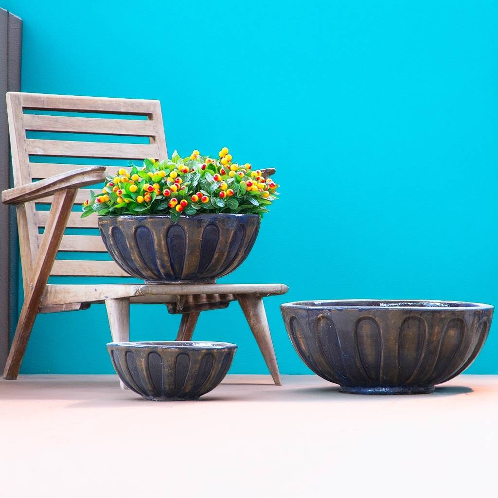 Round low bowl ceramic planters with a metallic bronze weathered finish, adding a rich, rustic touch