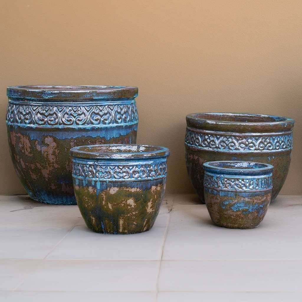 Distressed, wide-mouth ceramic planters featuring a multi-toned blue glaze with brown-green accents for a weathered, organic look