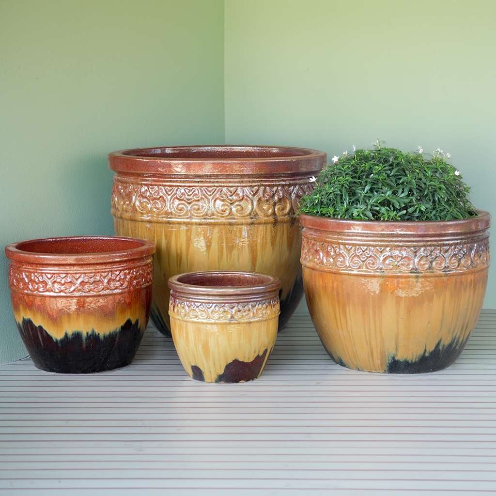 Multi-toned wide-mouth ceramic planters in tan and brown shades, featuring a dark brown base and a decorative glazed rim