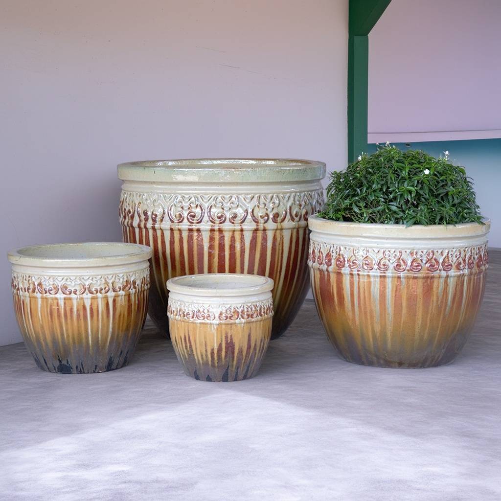 Multi-toned wide-mouth ceramic planters in tan and brown shades, featuring a charcoal-toned base and decorative white rim