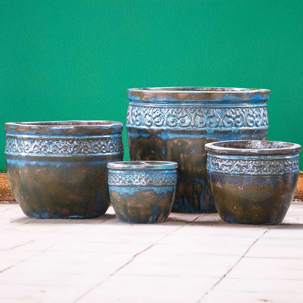 Distressed, multi-toned wide-mouth ceramic planters featuring a blue base with rich brown accents for a rustic, weathered look