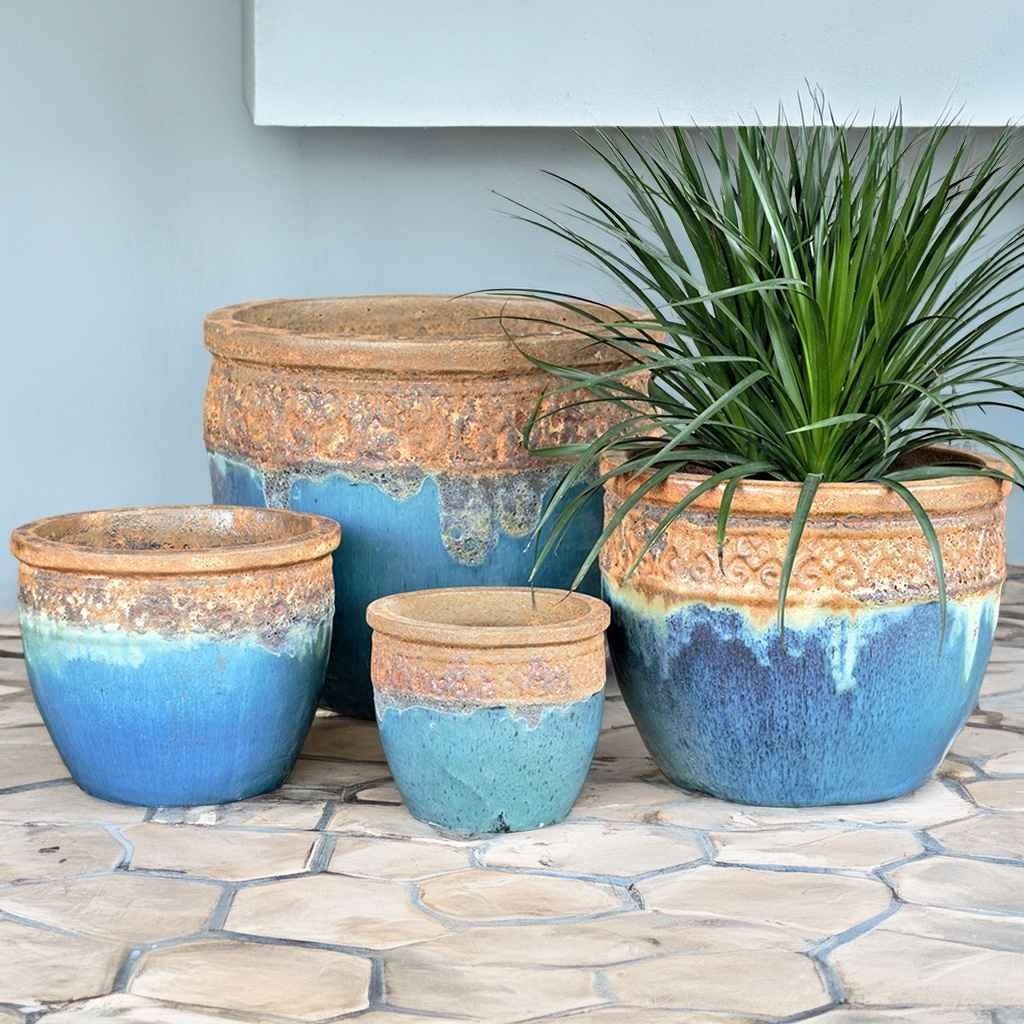 Rustic blue wide-mouth ceramic planter featuring a volcanic rust finish rim for a striking, natural contrast