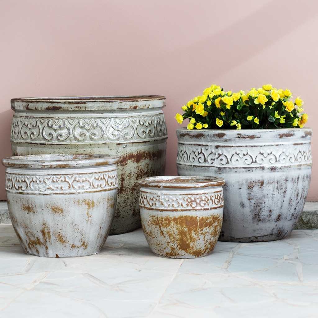Wide-mouth ceramic planter in antique-style white with muted brown tones and a decorative textured rim for a vintage, elegant look