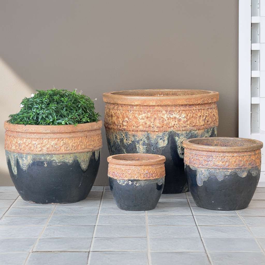 Rustic black wide-mouth ceramic planter with a textured volcanic rust finish rim for a striking natural contrast