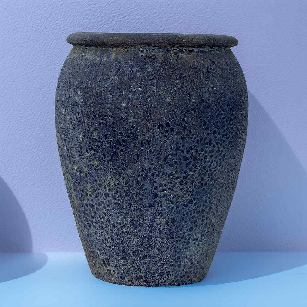 Large egg-shaped planter in dark mottled blue-gray for a rich, textured appearance