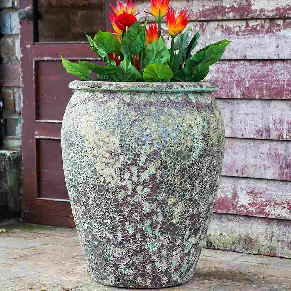 Large egg-shaped planter in Atlantis Burnt Green, featuring a rich, textured glaze with earthy green tones