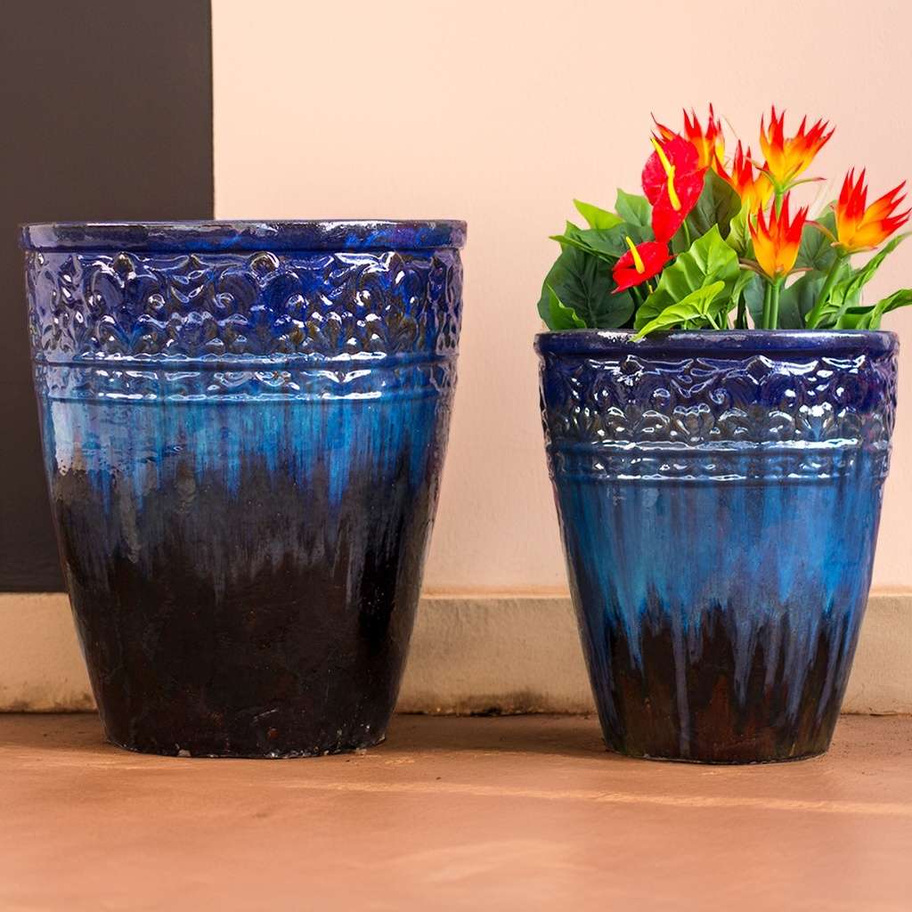 Tall round ceramic planters in blue with black tones, featuring embossed banding