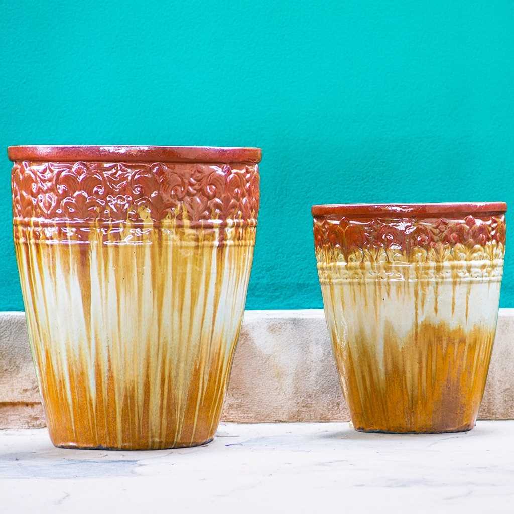 Tall, round ceramic planters in tan and brown with a streaked glazed finish and decorative embossed banding