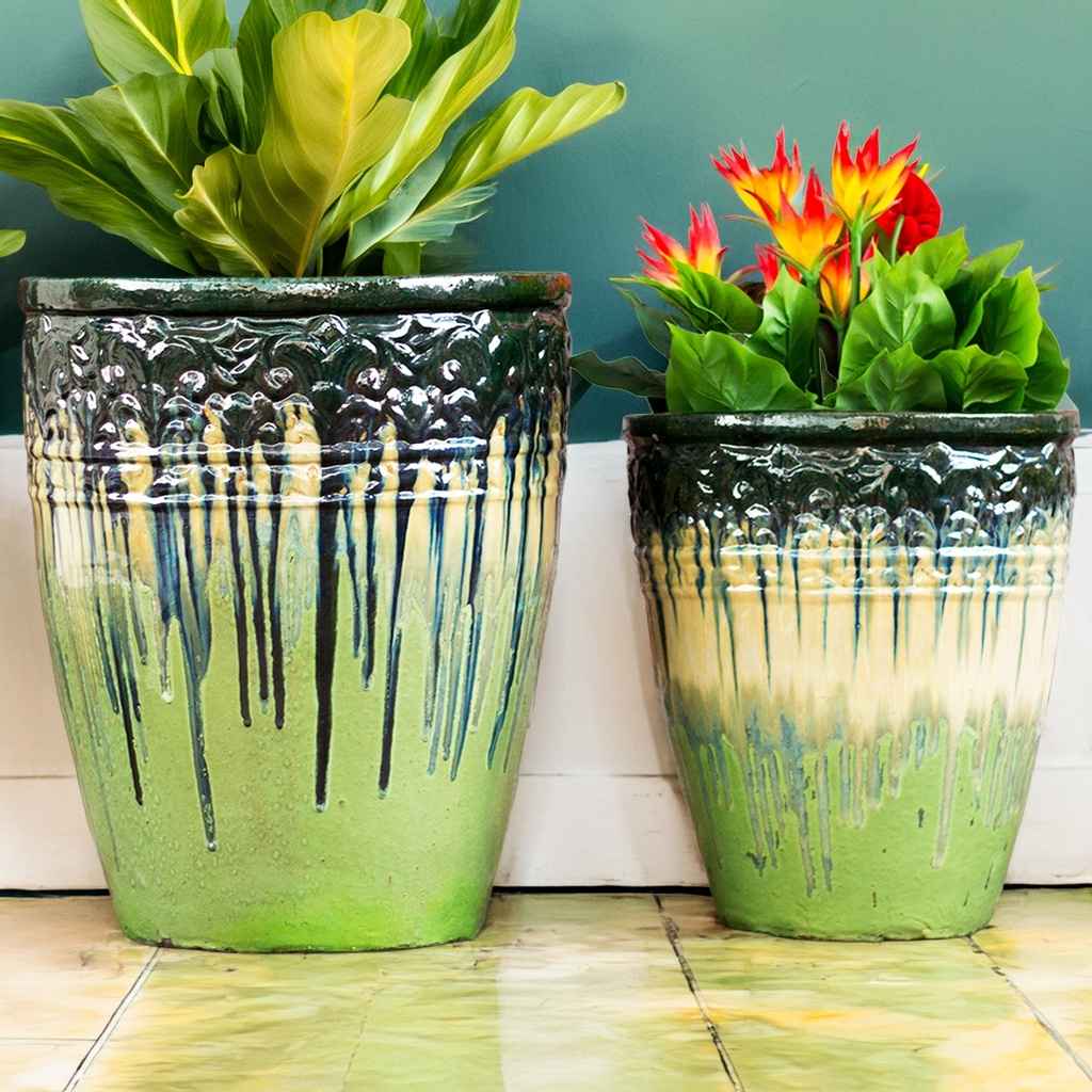 Tall round ceramic planters in light green featuring embossed banding and a dark green dripping glaze effect