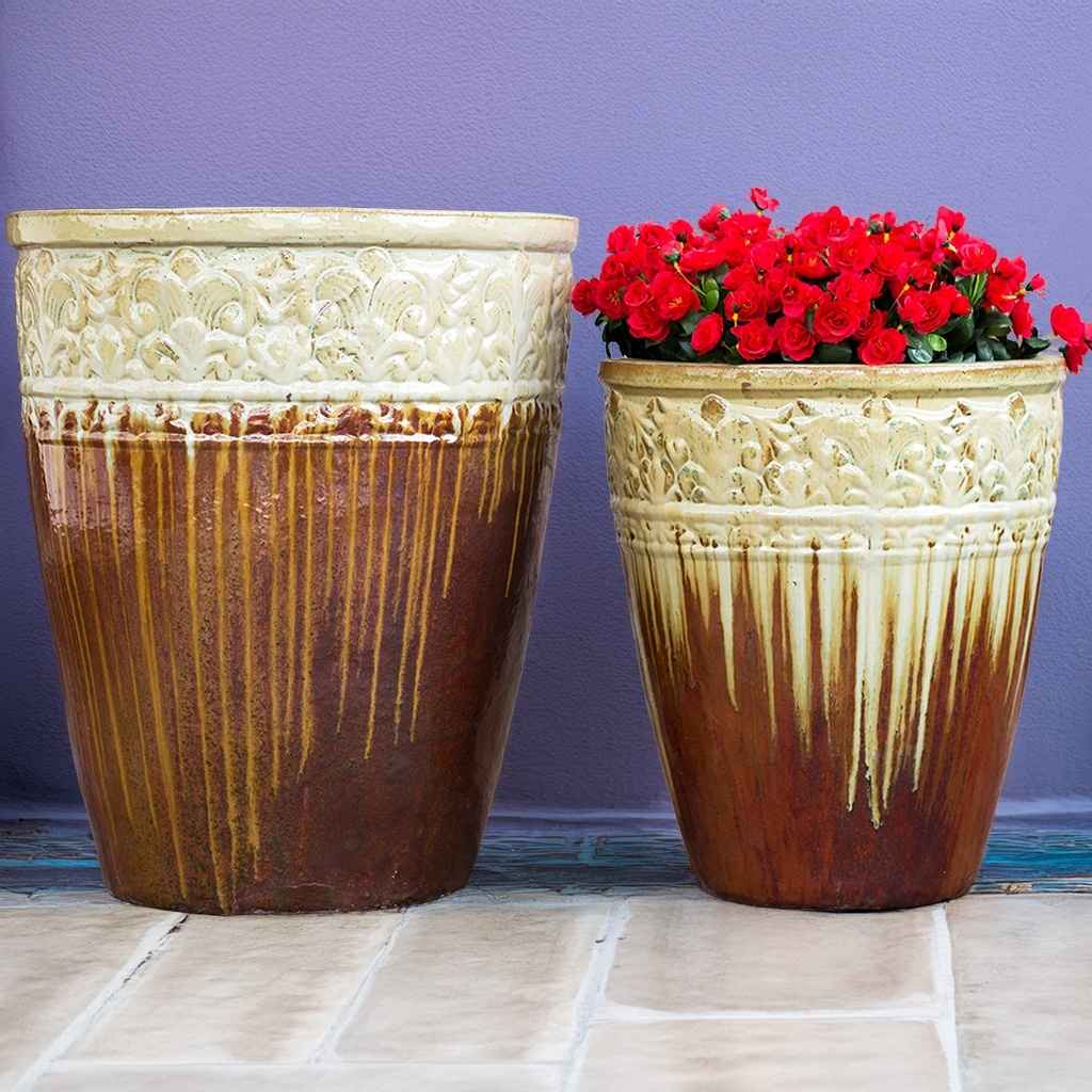 Tall, round ceramic planters in cream and brown with a streaked glazed finish and decorative embossed banding