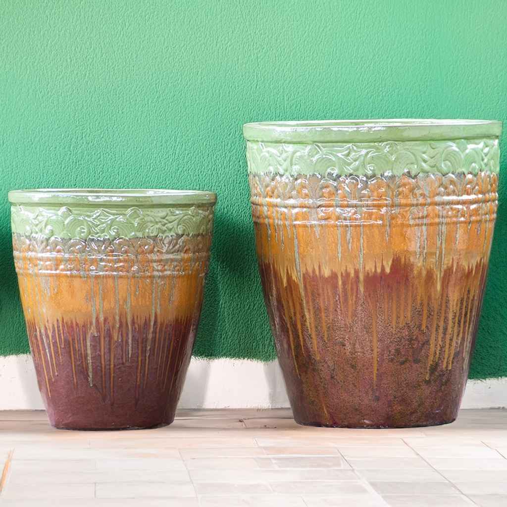 Tall, round ceramic planters featuring a multi-toned glaze in shades of green, brown, and reddish-brown, with a drip-glaze effect and decorative embossed banding