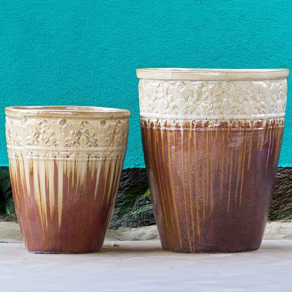 Tall, round ceramic planters in brown and cream  with a streaked glazed finish and decorative embossed banding