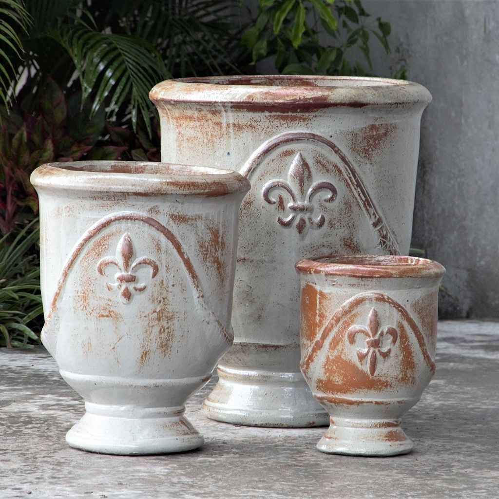Classic white urn planter set with reddish-brown accents and embossed Fleur-de-Lis design for an elegant, vintage look