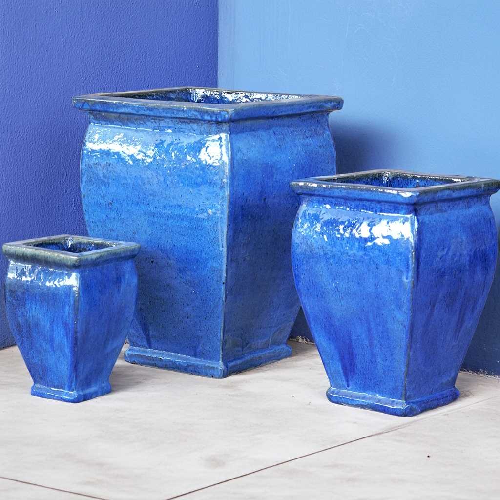 Flared square-rimmed ceramic planter with a glossy blue finish