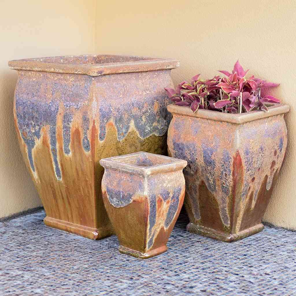 Flared square-rimmed ceramic planter in distressed brown, featuring a dripped glaze pattern in blue, purple, and reddish-orange for a bold, artistic finish