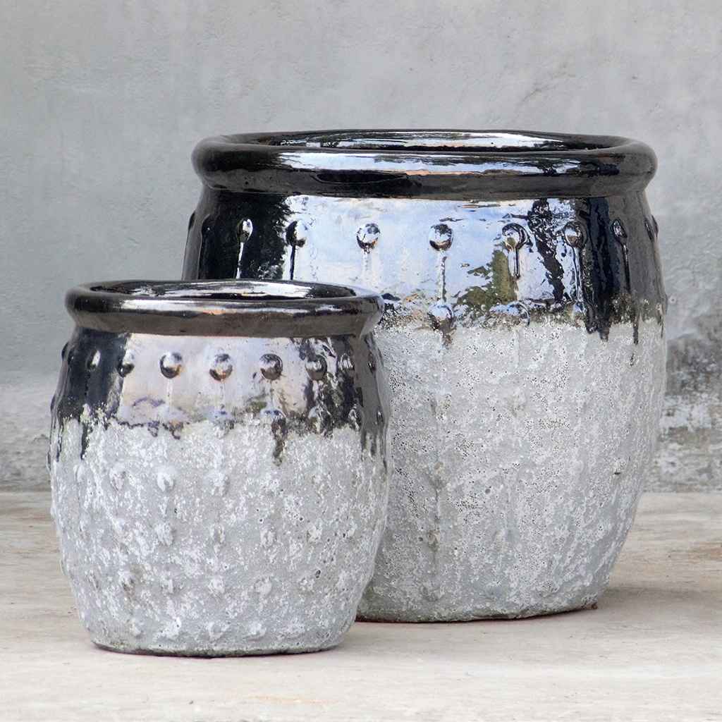 Rounded ceramic planters in textured grey with a glossy black top and vertical dotted ridges