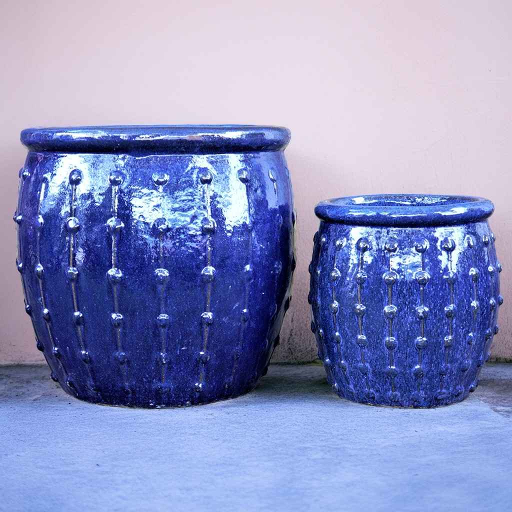 Rounded ceramic planters in glossy blue with vertical dotted ridges