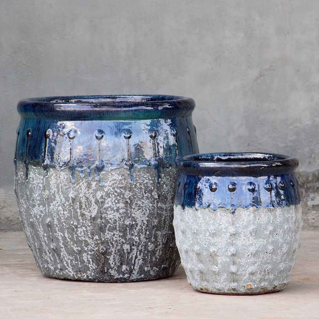 Rounded ceramic planters with textured grey body, glossy blue-green top, and vertical dotted ridges