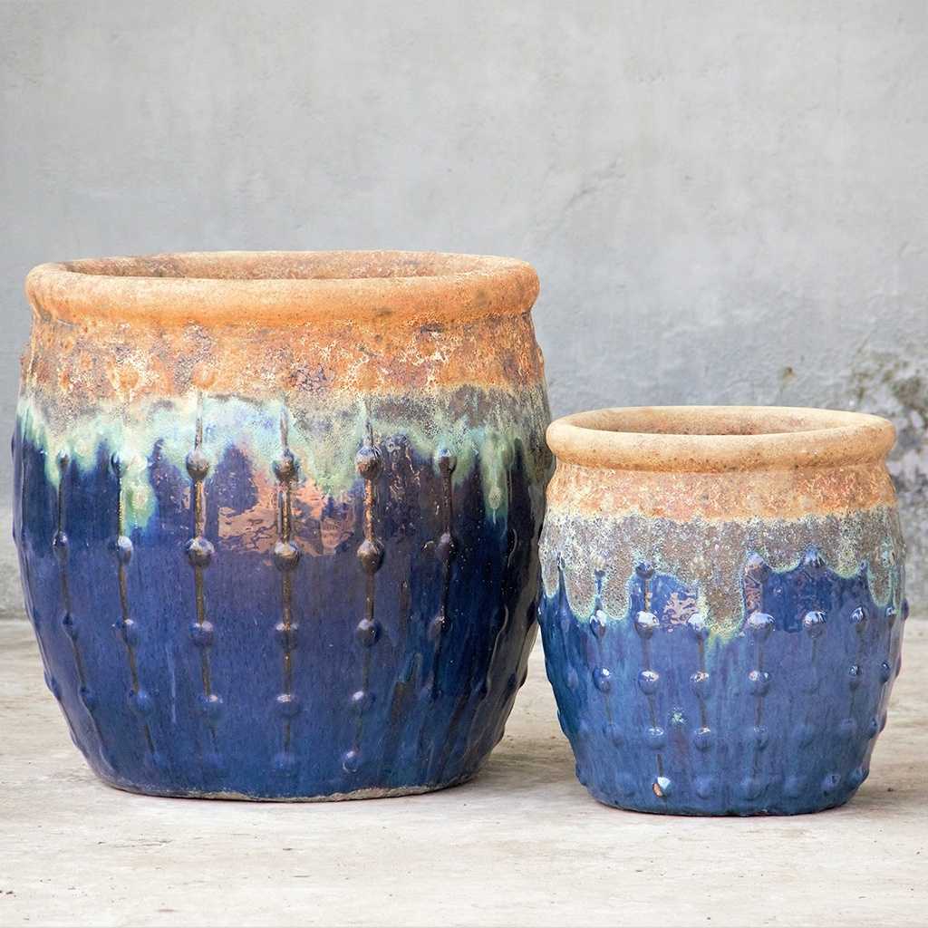 Rounded dark blue planters featuring a rustic top with textured dripping glaze and vertical dotted ridges