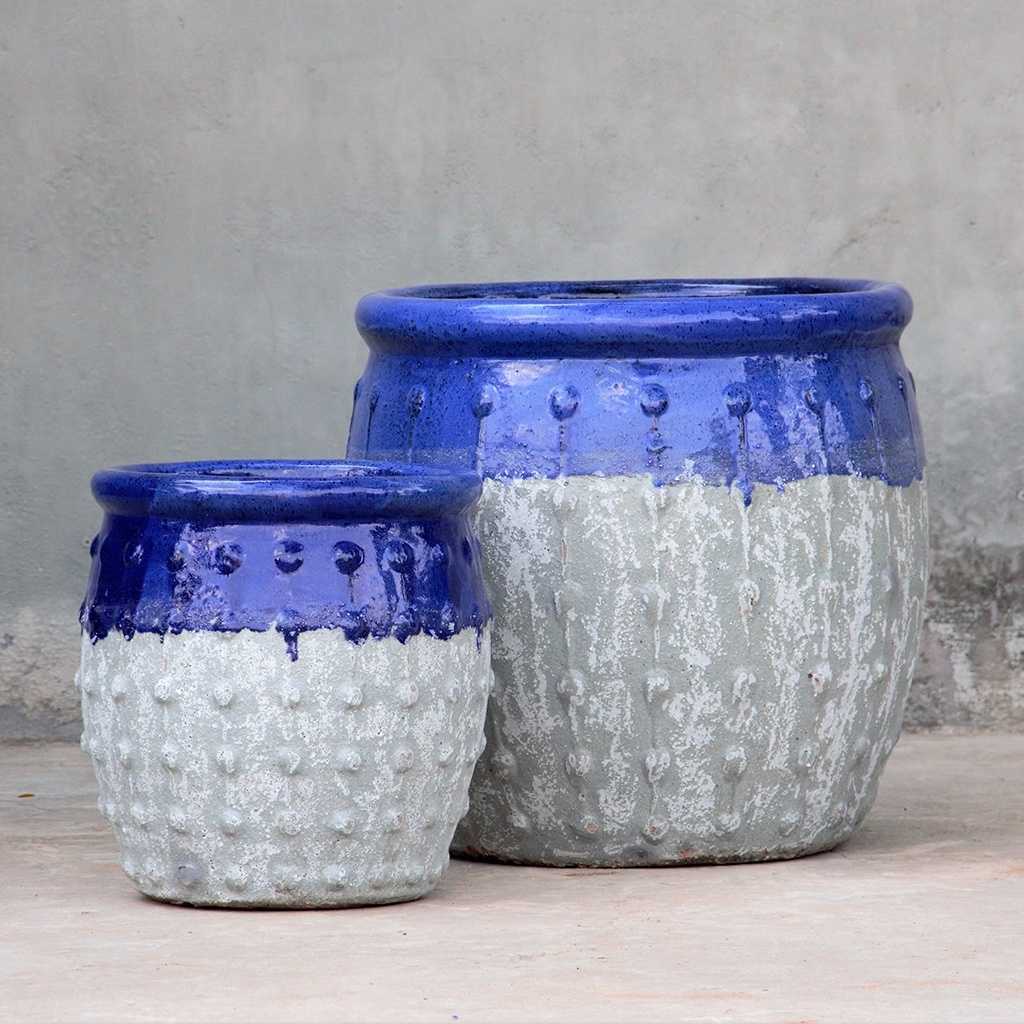 Rounded ceramic planters with textured grey body, glossy dark blue top, and vertical dotted ridges