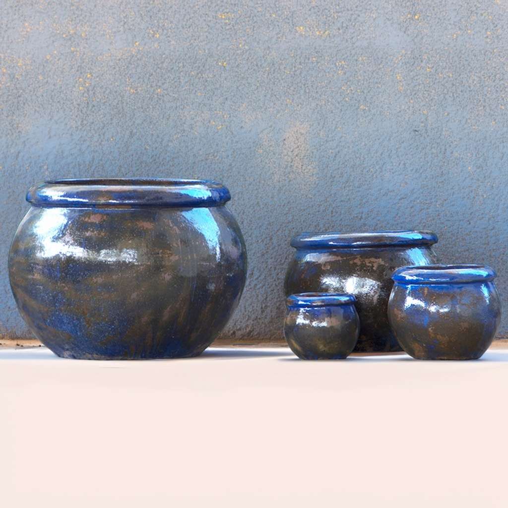 Round ceramic planters with a glossy blue-brown finish