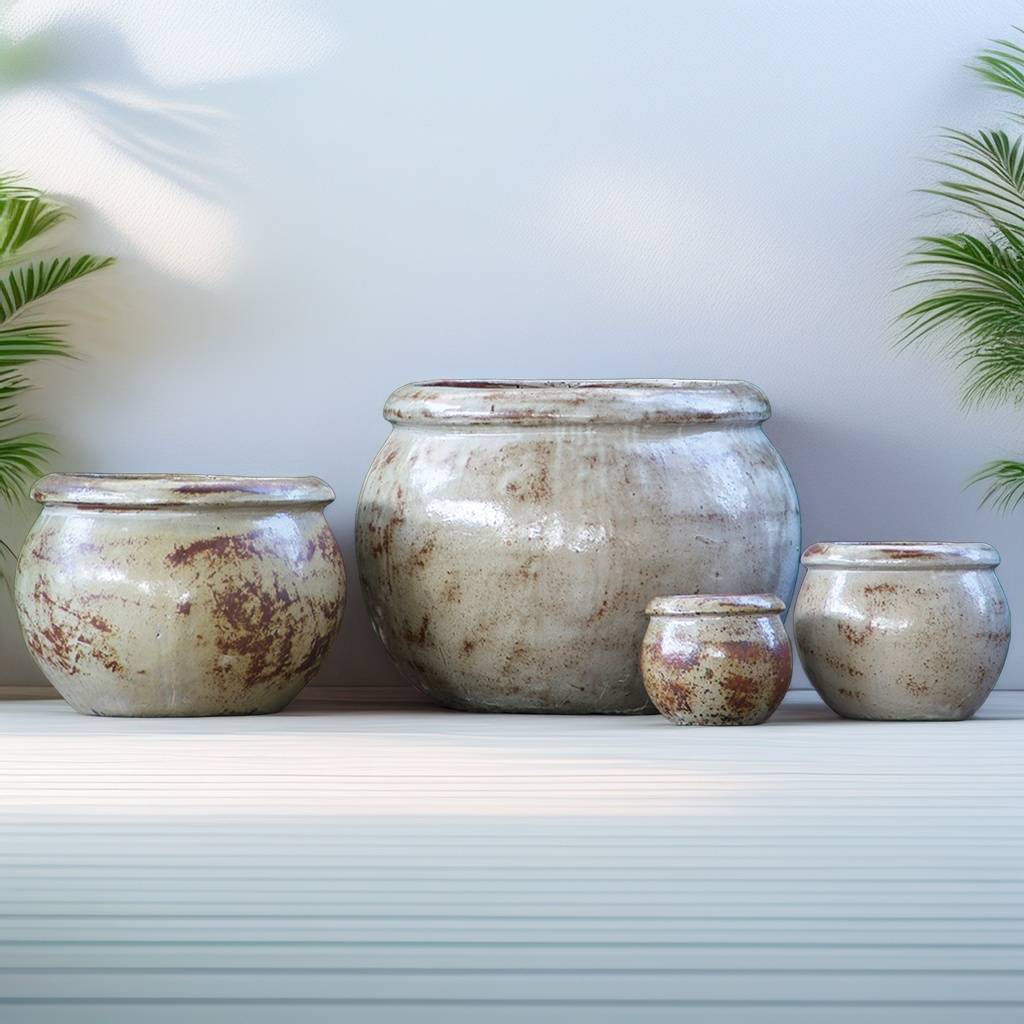 Round ceramic planters with a rustic whitewashed finish