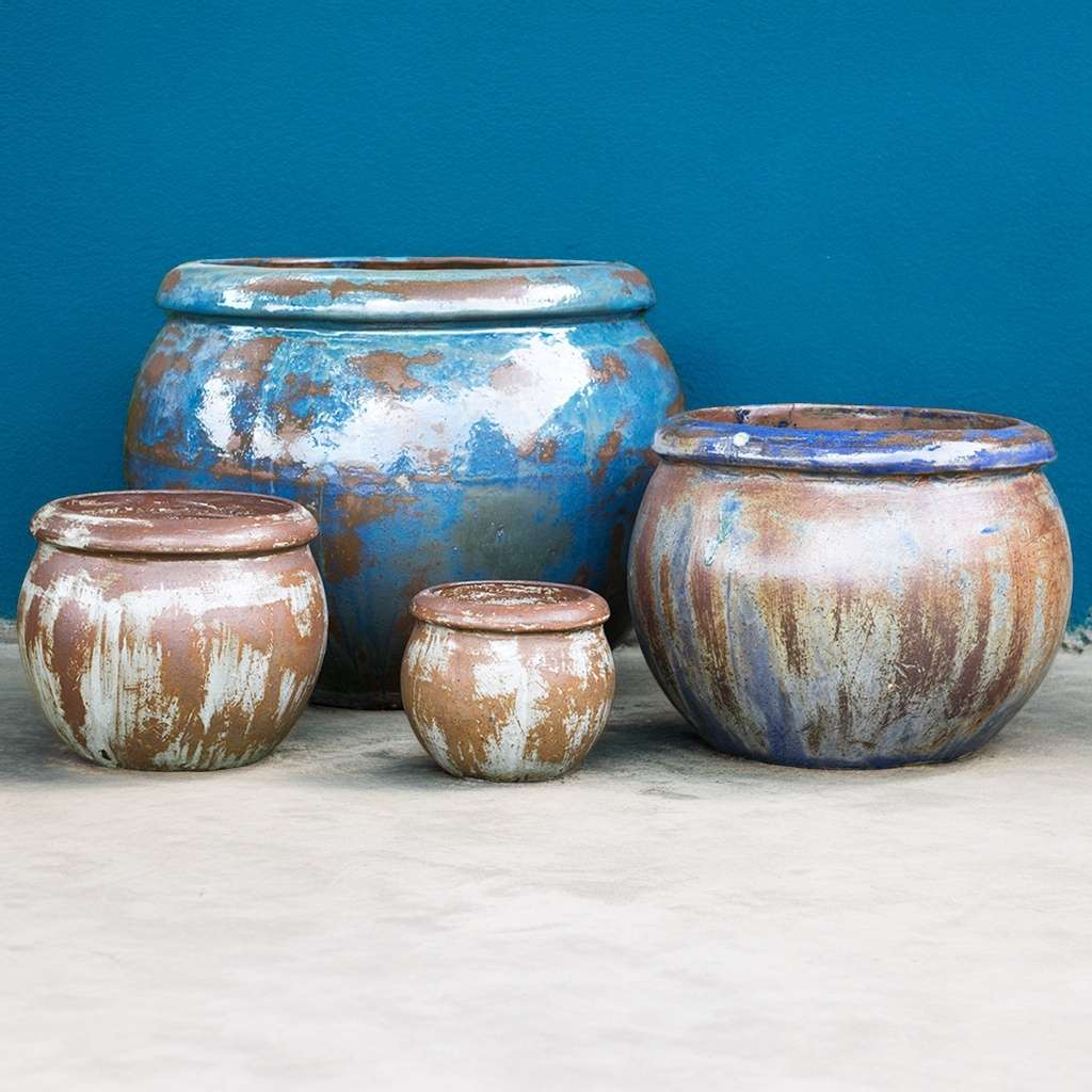 Round ceramic planters featuring a rustic finish with rich brown and blue tones for an earthy, handcrafted look