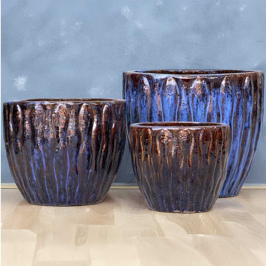 Ceramic planter featuring a wavy pattern design with a blue and brown glaze
