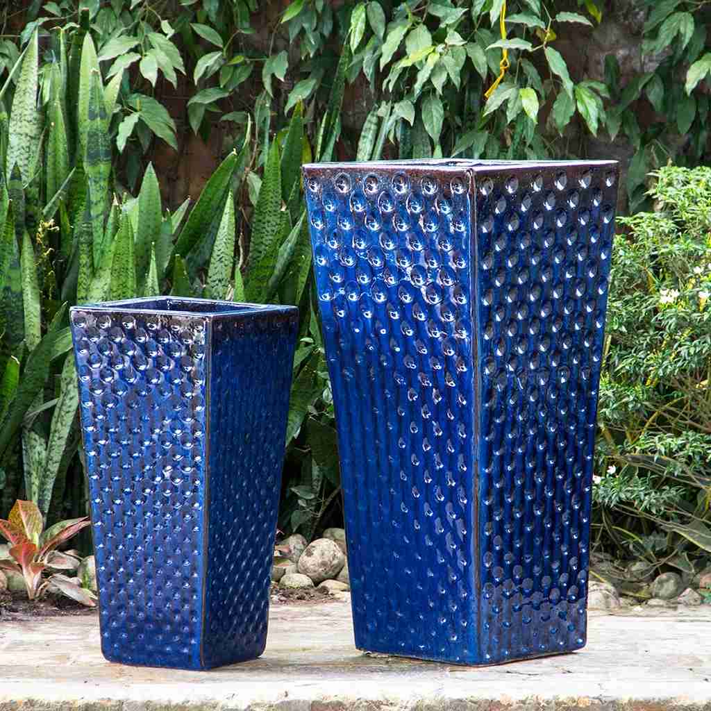 Square ceramic planter with dimpled texture in dark blue, accented by subtle brown details