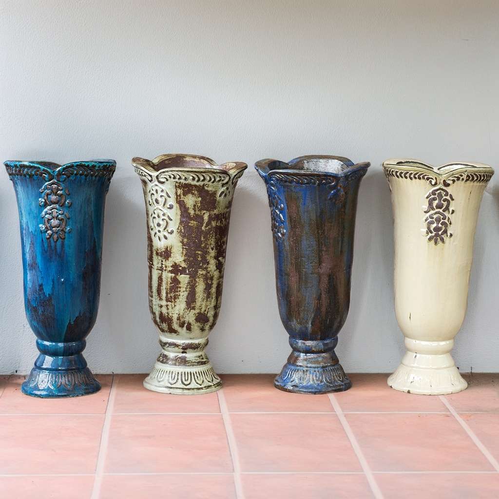 Set of 4 pedestal vase planters, each featuring a unique finish—glossy blue, distressed white, rich blue-brown, and smooth cream