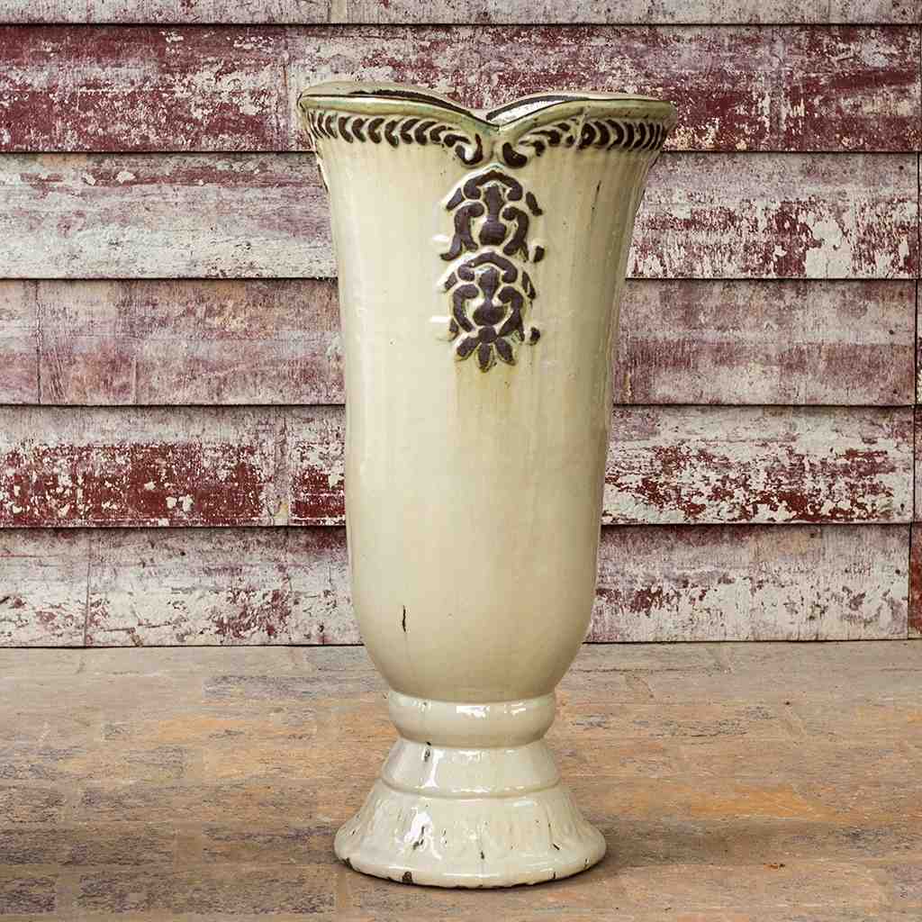 Glossy cream pedestal vase planter featuring an embossed flower design