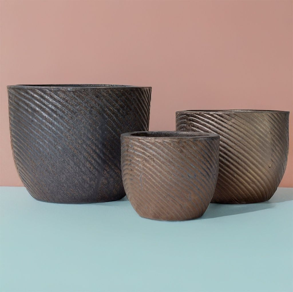 Ridged round planters featuring a textured surface in black and brown tones