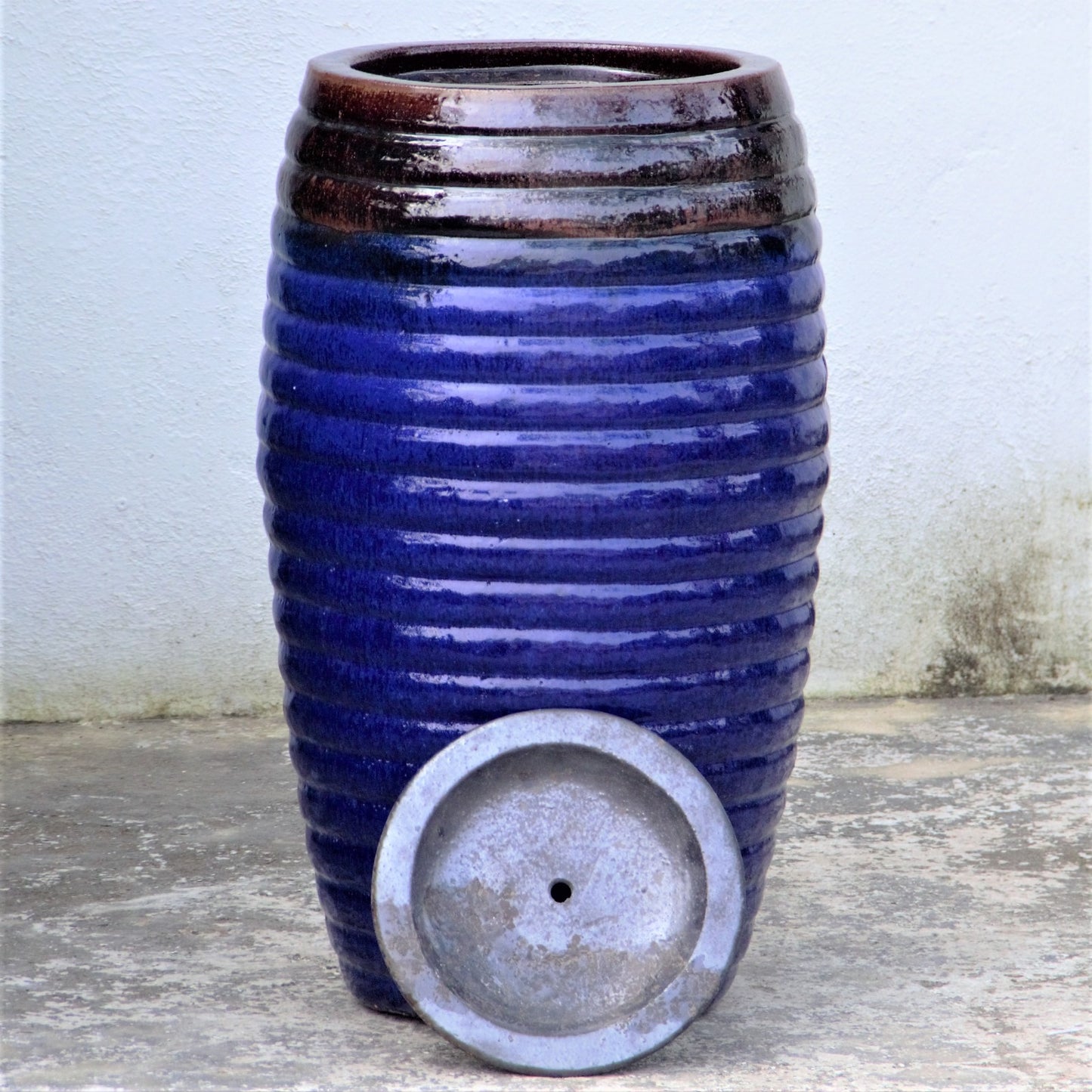 Glossy blue black ribbed fountain jar