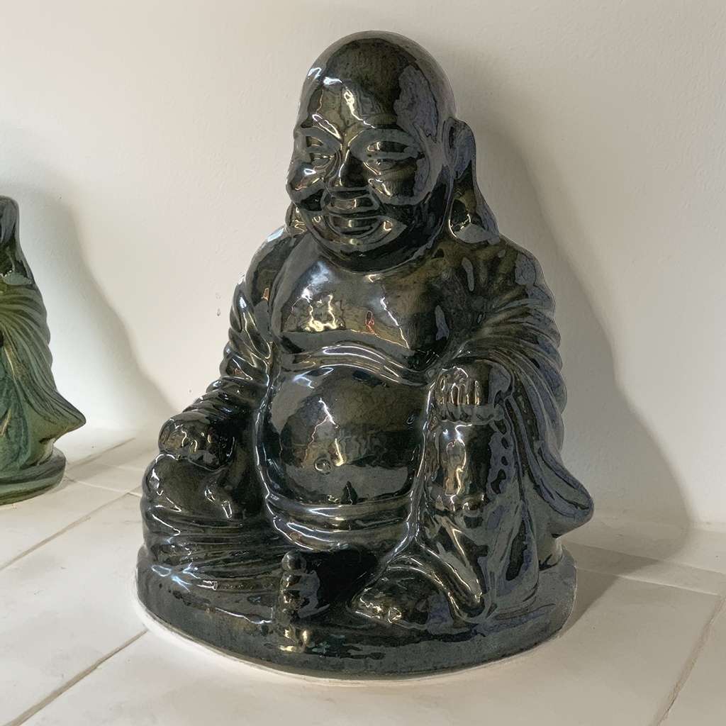 Glossy black Buddha statues with smooth surfaces and detailed serene expressions