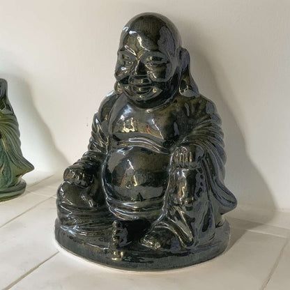 Glossy black Buddha statues with smooth surfaces and detailed serene expressions