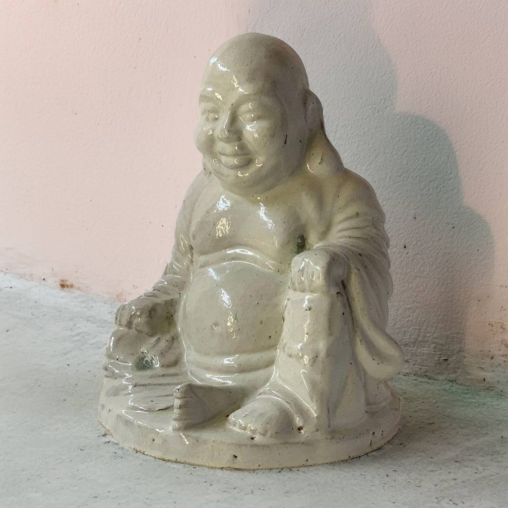 Off-white glossy Laughing Buddha figures with smooth, polished surfaces and joyful expressions