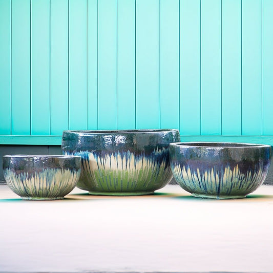 Wide, low bowl planters featuring light green and cream tones with a blue-black rim and drip-like patterns