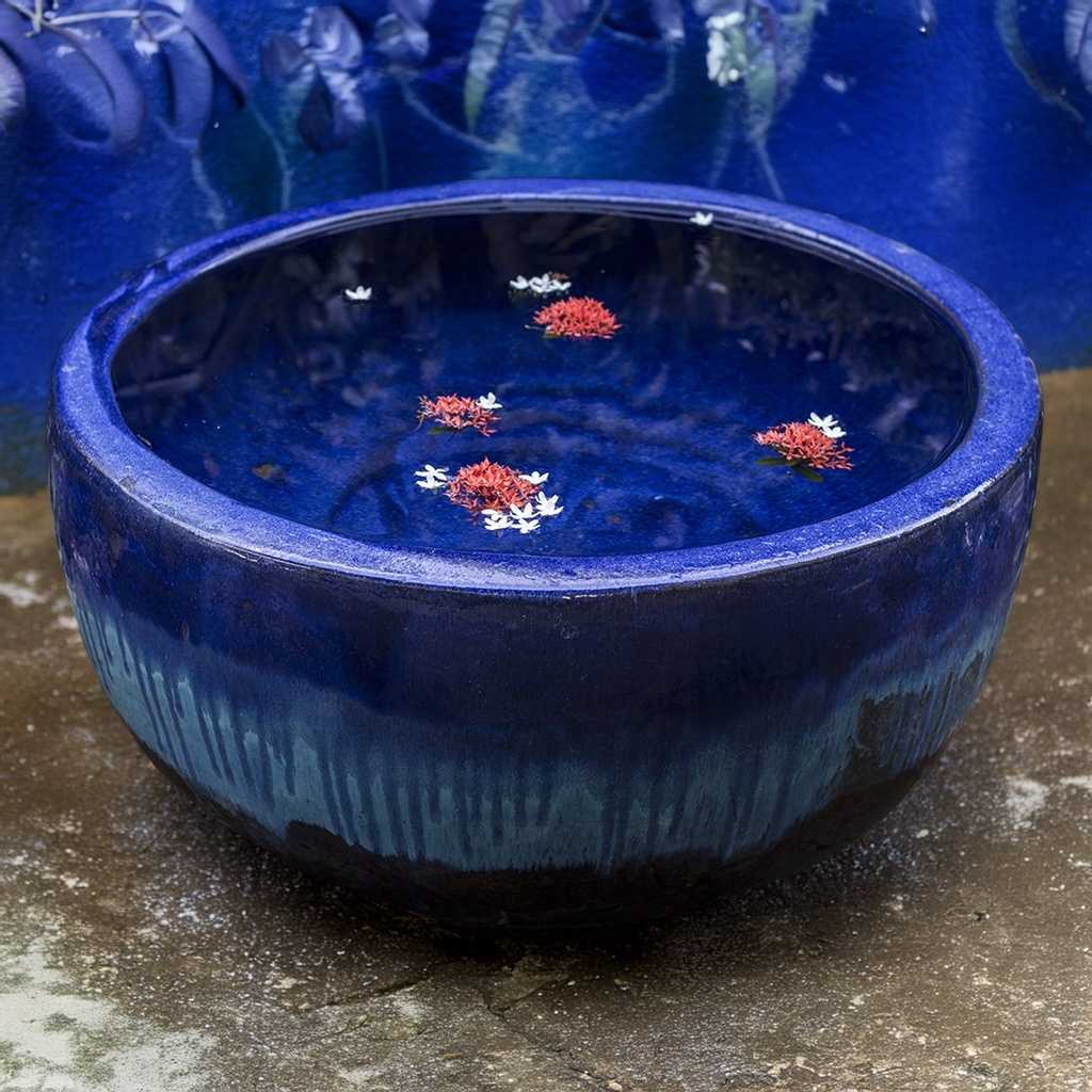 Wide round planter pot in blue and brown with a striking dripping glaze effect