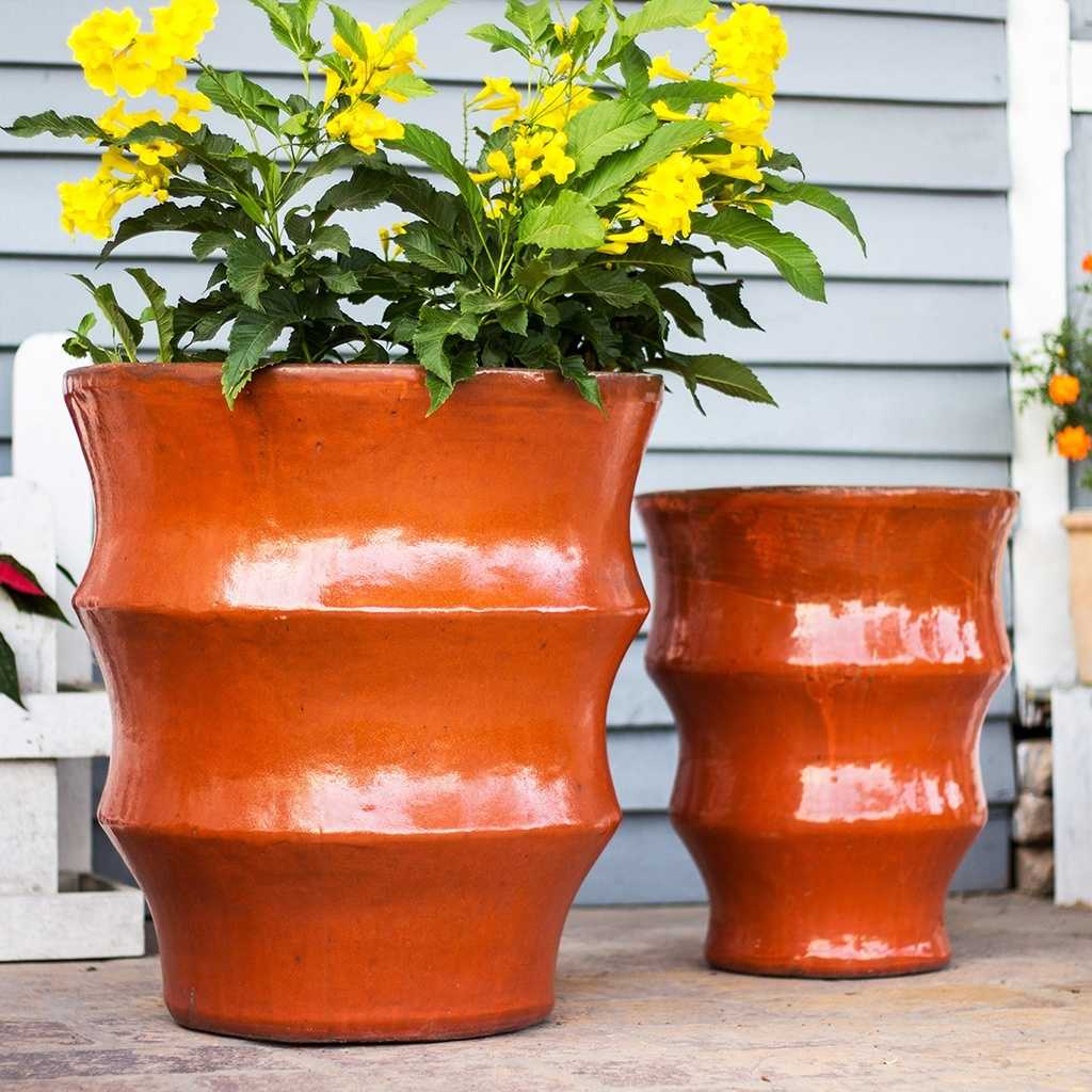 Orange ceramic planters with a ripple contour texture