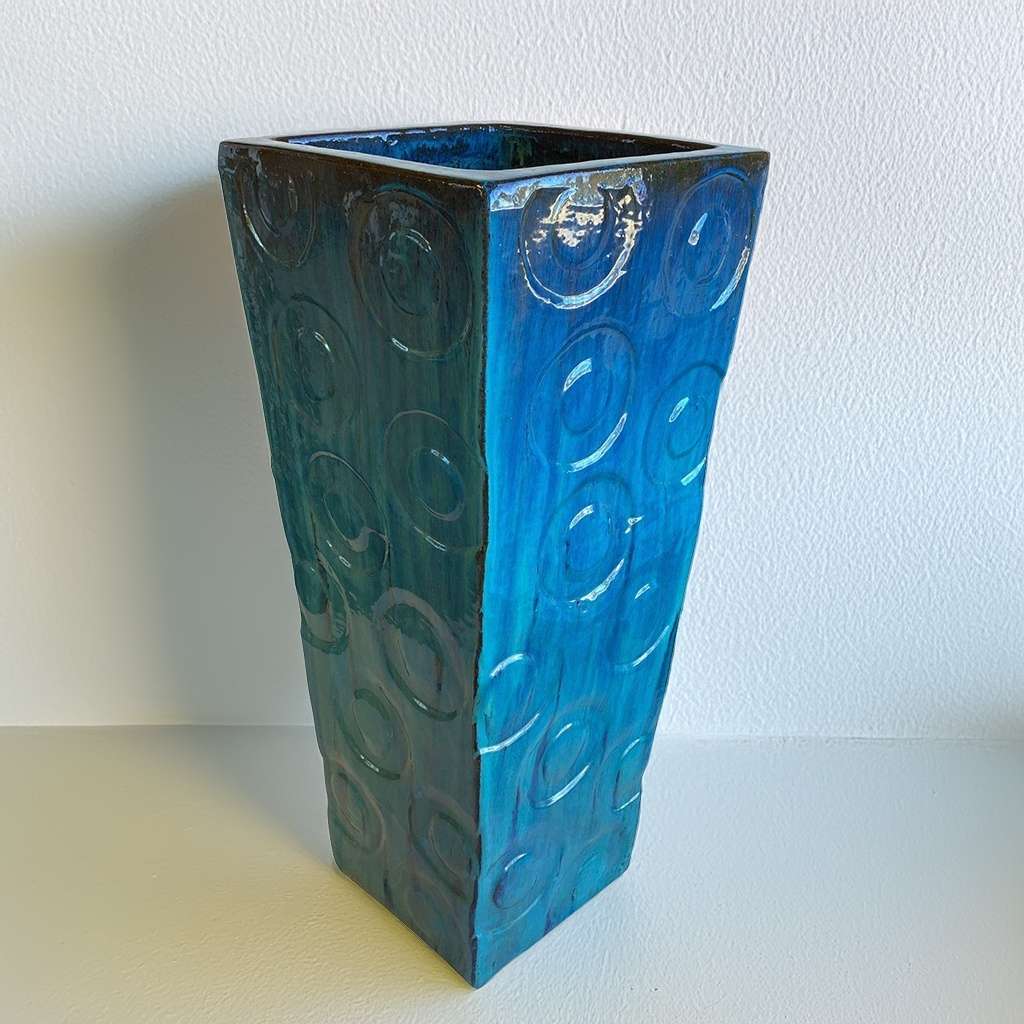 Tall square planter in glossy blue featuring elegant embossed circular patterns for a stylish, textured look