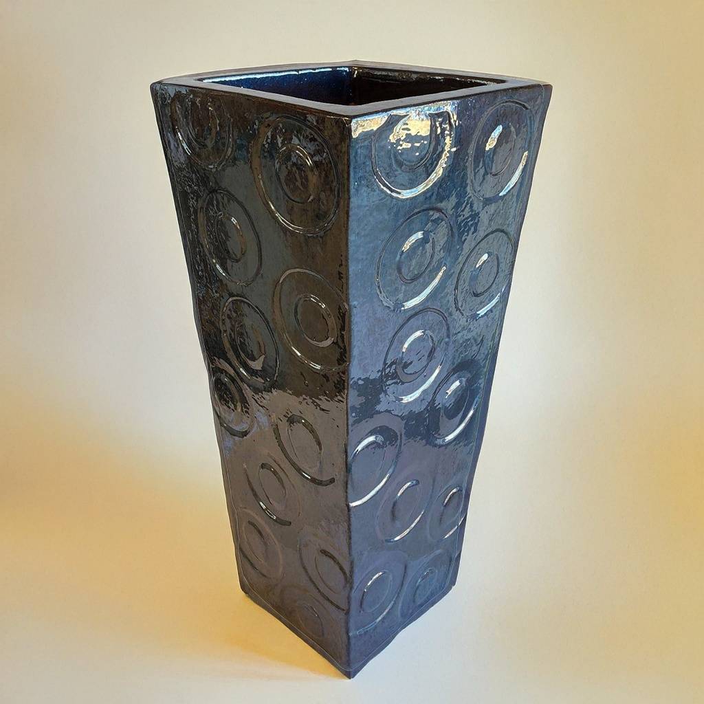 Tall square planter in glossy dark blue featuring elegant embossed circular patterns for a sophisticated textured design