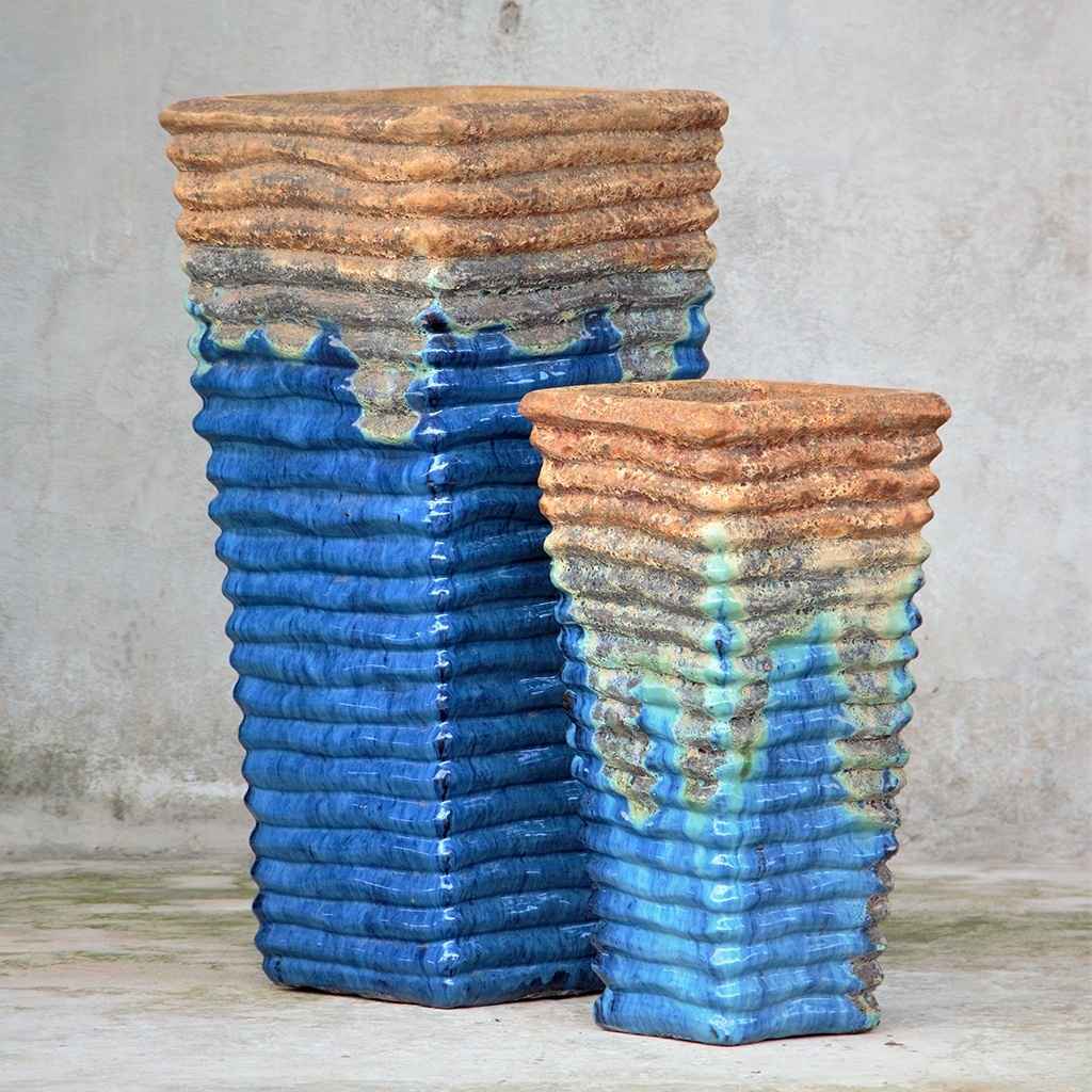 Tall, wavy ceramic planters in cream blue with distressed brown-orange rim