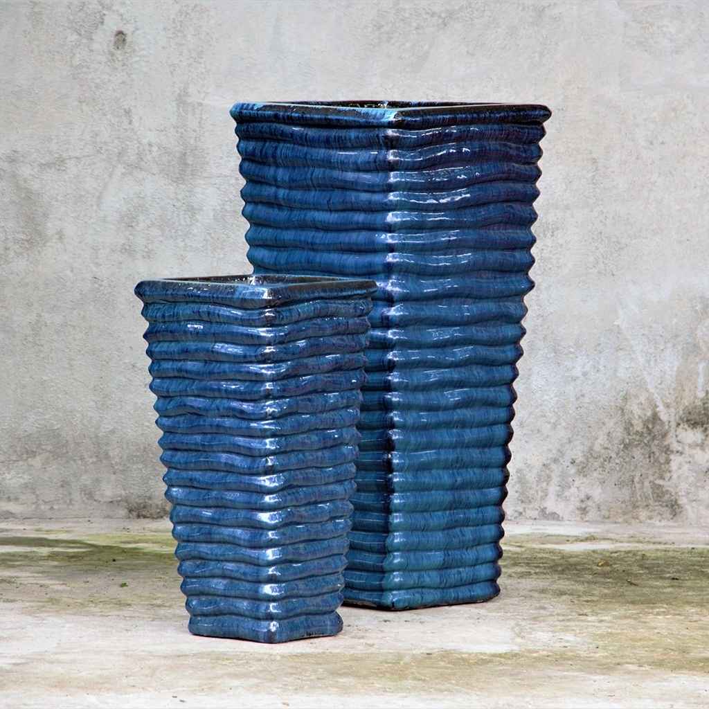 Tall, glazed ceramic planters in vibrant blue