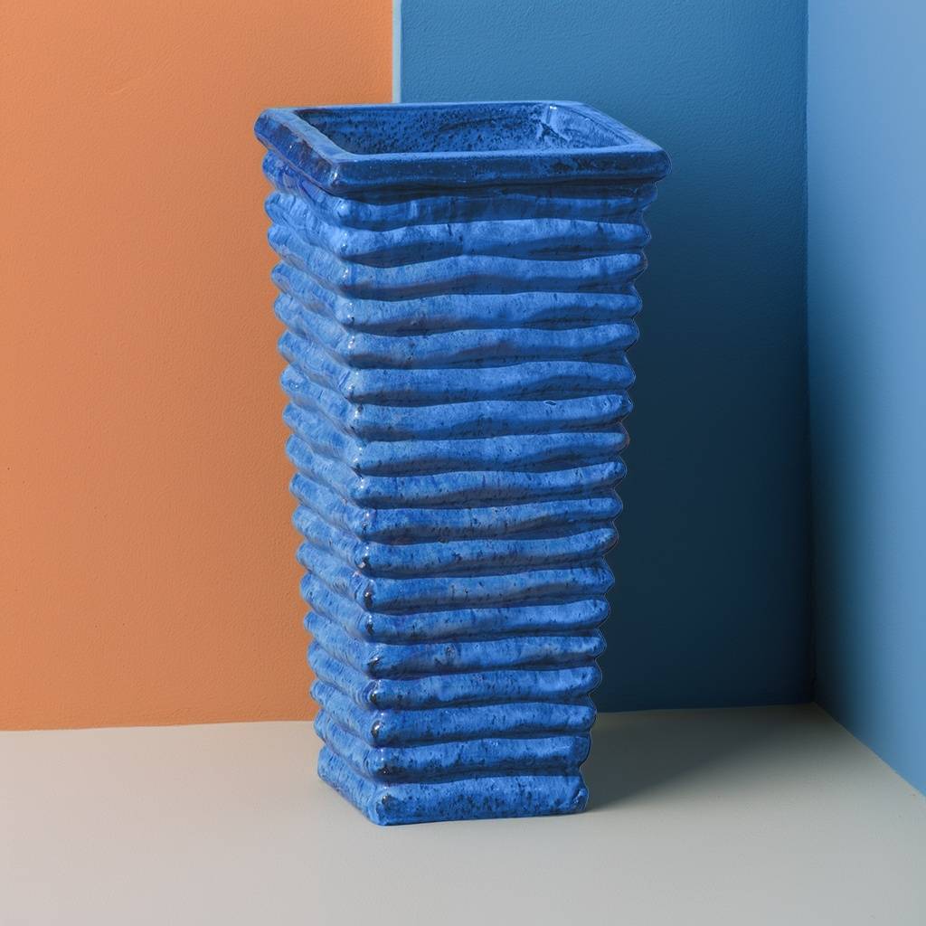 Tall, wavy ceramic planter in blue